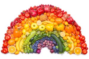 Fresh fruits and vegetables form a rainbow in color and shape