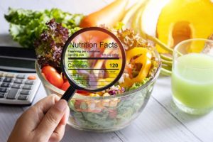 Nutritional information depicted in magnifying glass zooming in on salad bowl